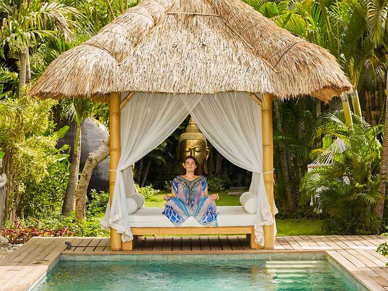woman meditating by the pool at bliss bali retreat