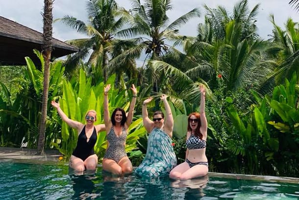 Friends laughing having fun poolside at Bliss Bali retreat