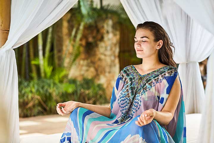 Bliss Bali retreat guest meditating in beautiful setting